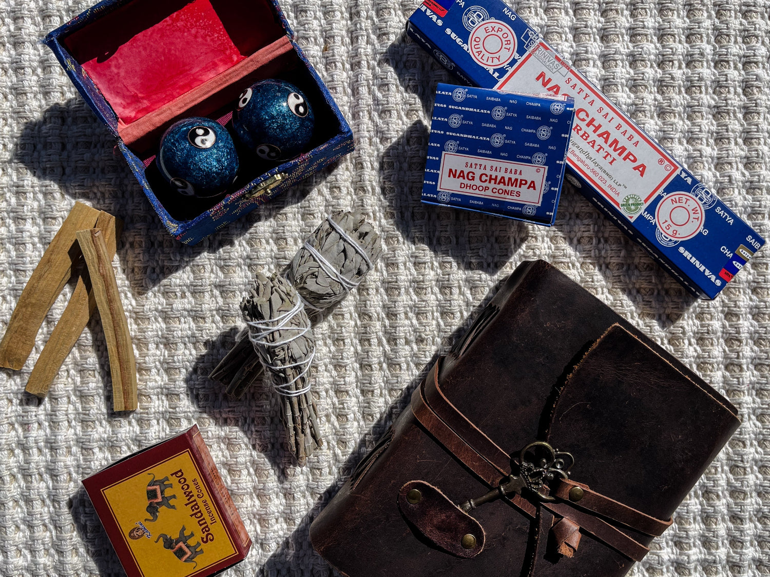 Collection of Nag Champa incense products on a textured surface