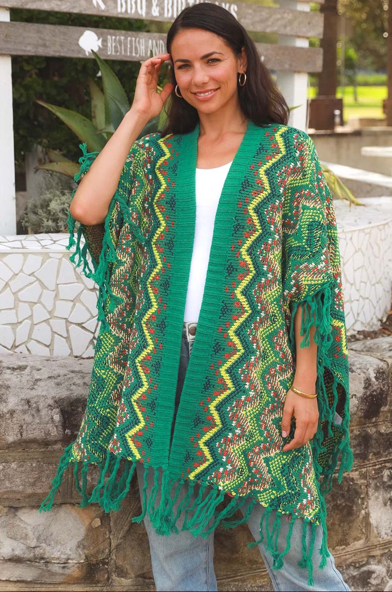 Woman wearing a green and yellow patterned kimono-style garment outdoors.