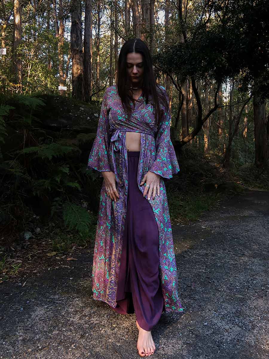 Woman in a patterned kimono standing in a forest