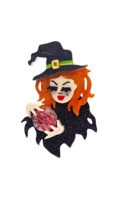 A woman's brooch depicts a witch holding a crystal ball.