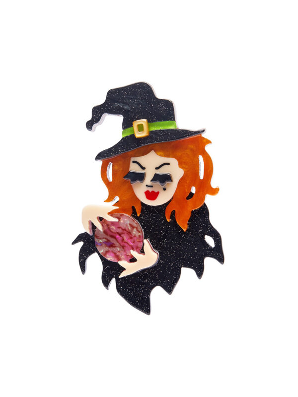 A woman's brooch depicts a witch holding a crystal ball.