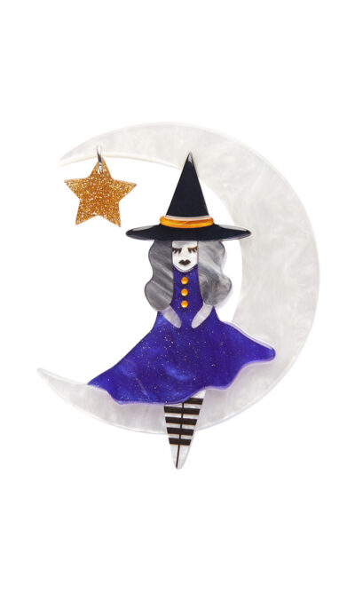 A woman's brooch depicts a witch sitting on a crescent moon with a star.