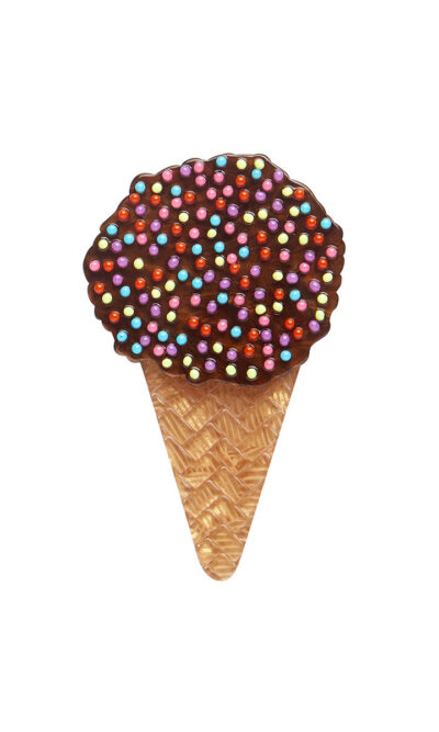 A woman's brooch depicts an ice cream cone cake with sprinkles.