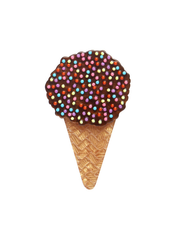 A woman's brooch depicts an ice cream cone cake with sprinkles.