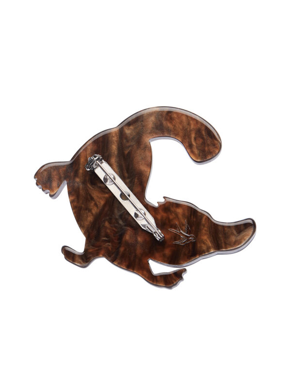 A woman's brooch depicts a swimming platypus.